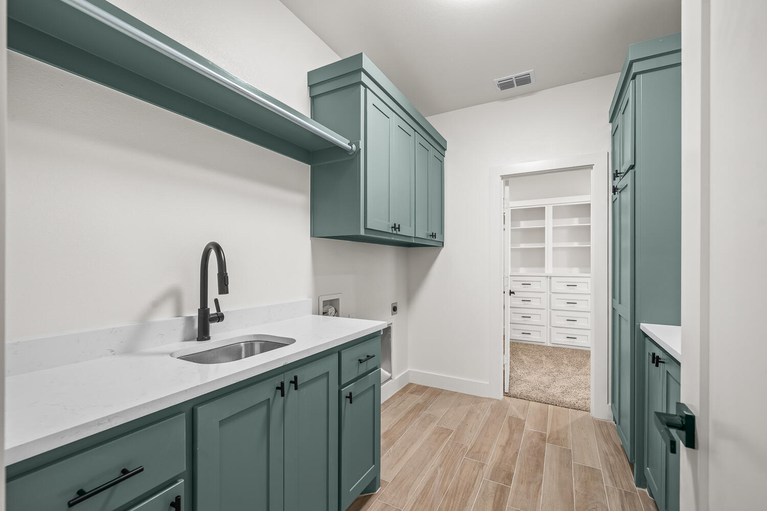 7205 East F M 41 Slaton, TX 79364 - Photo 15 of 47 a kitchen with a sink a refrigerator and cabinets