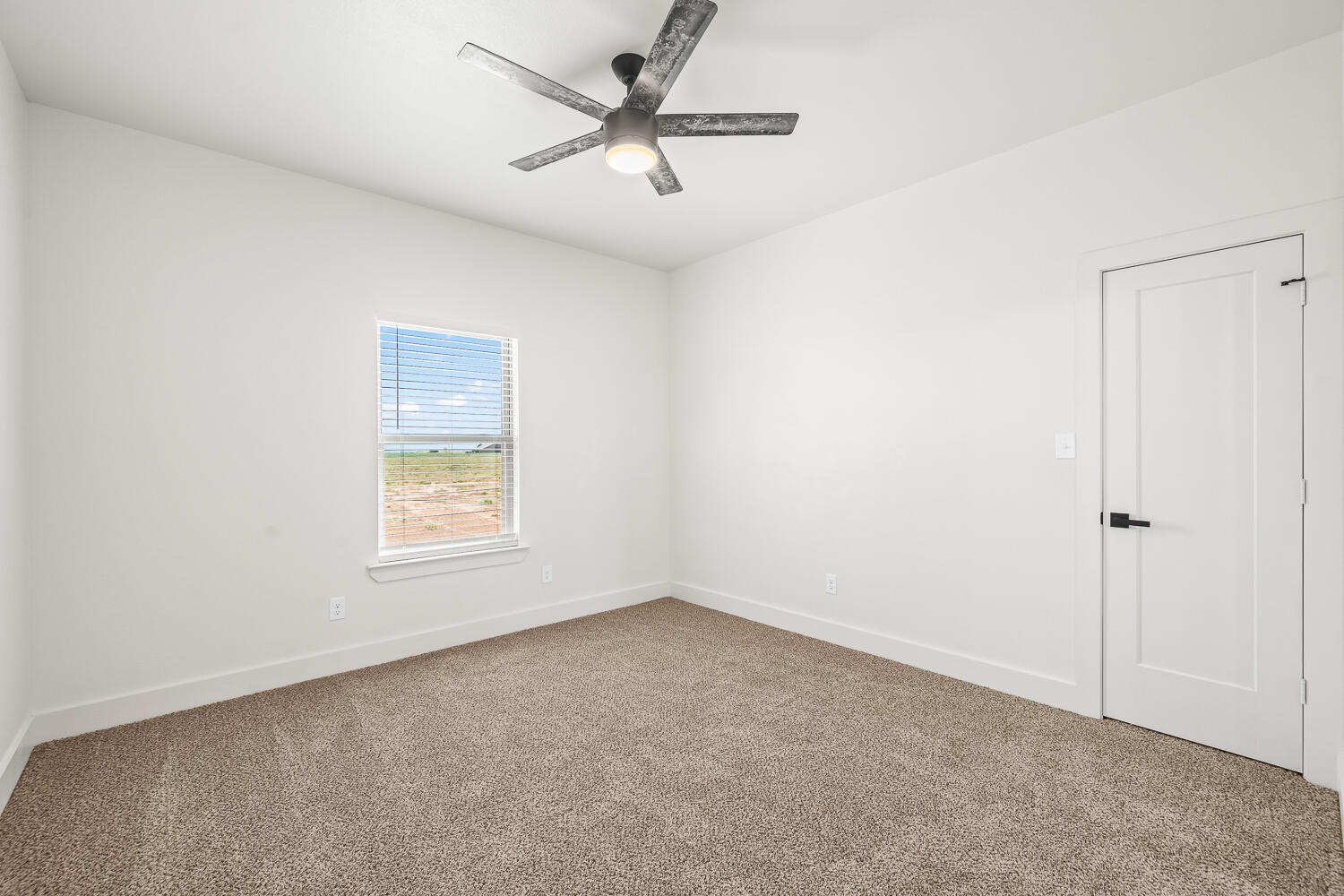 7205 East F M 41 Slaton, TX 79364 - Photo 26 of 47 an empty room with a window and a fan