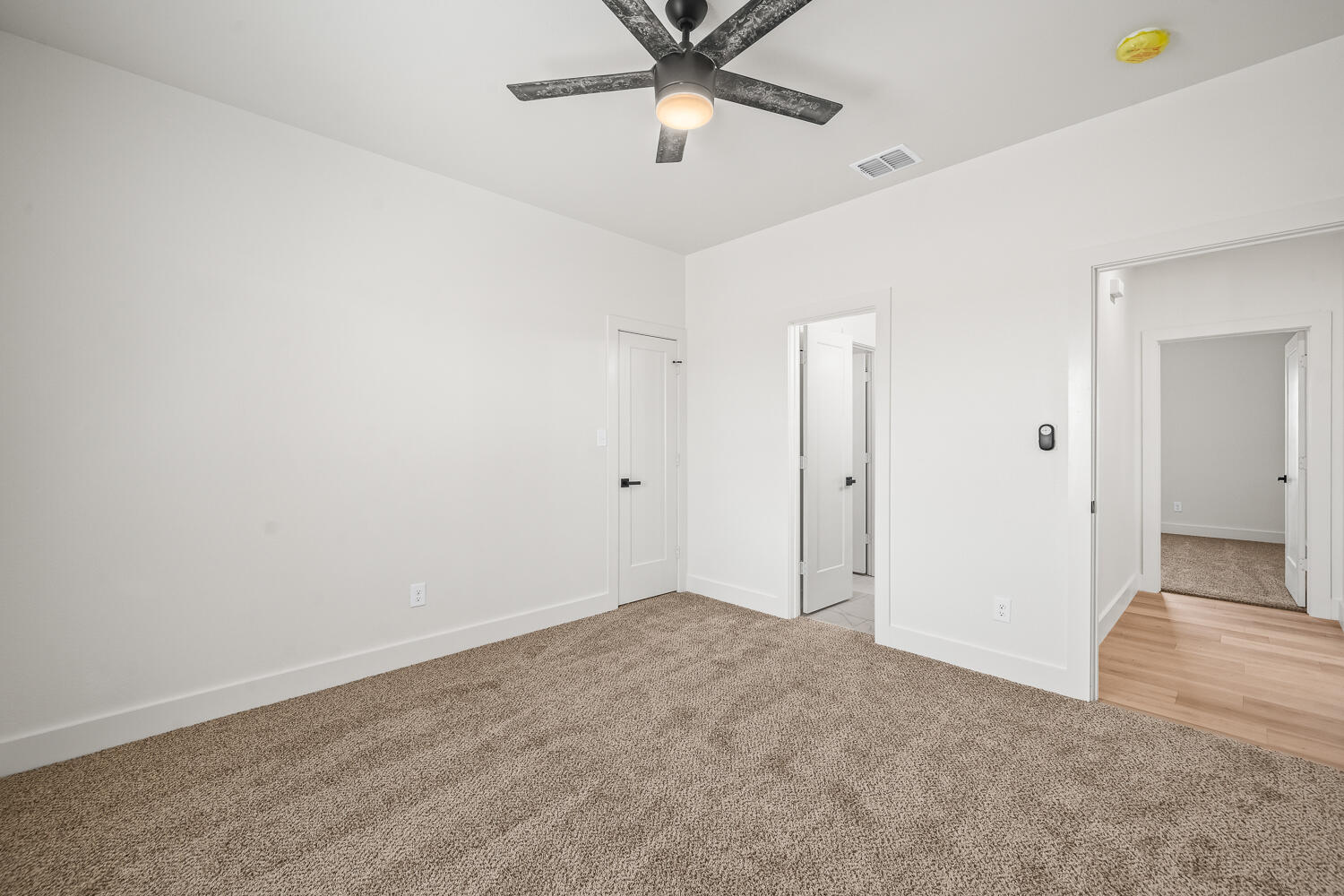 7205 East F M 41 Slaton, TX 79364 - Photo 27 of 47 an empty room with closet and a chandelier fan