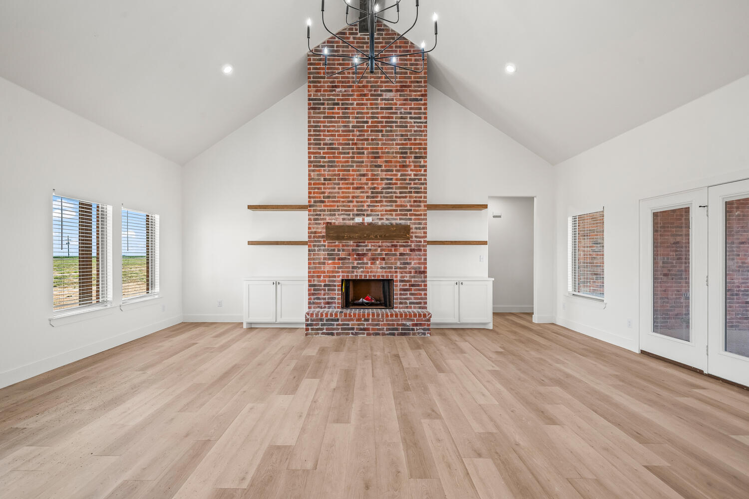 7205 East F M 41 Slaton, TX 79364 - Photo 39 of 47 a view of empty room with wooden floor and fireplace