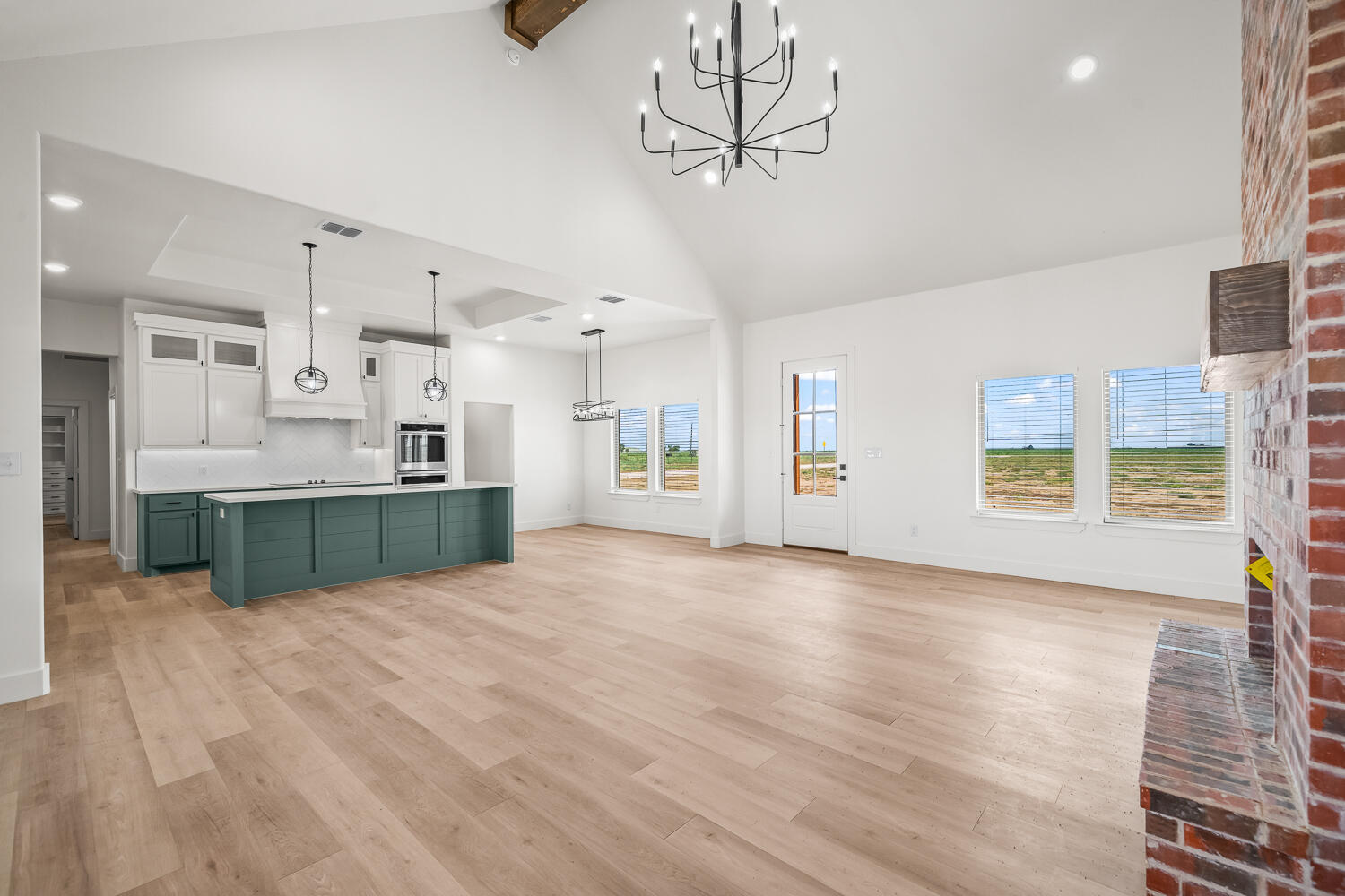 7205 East F M 41 Slaton, TX 79364 - Photo 42 of 47 a view of a kitchen with a sink hardwood floor and a kitchen counter space