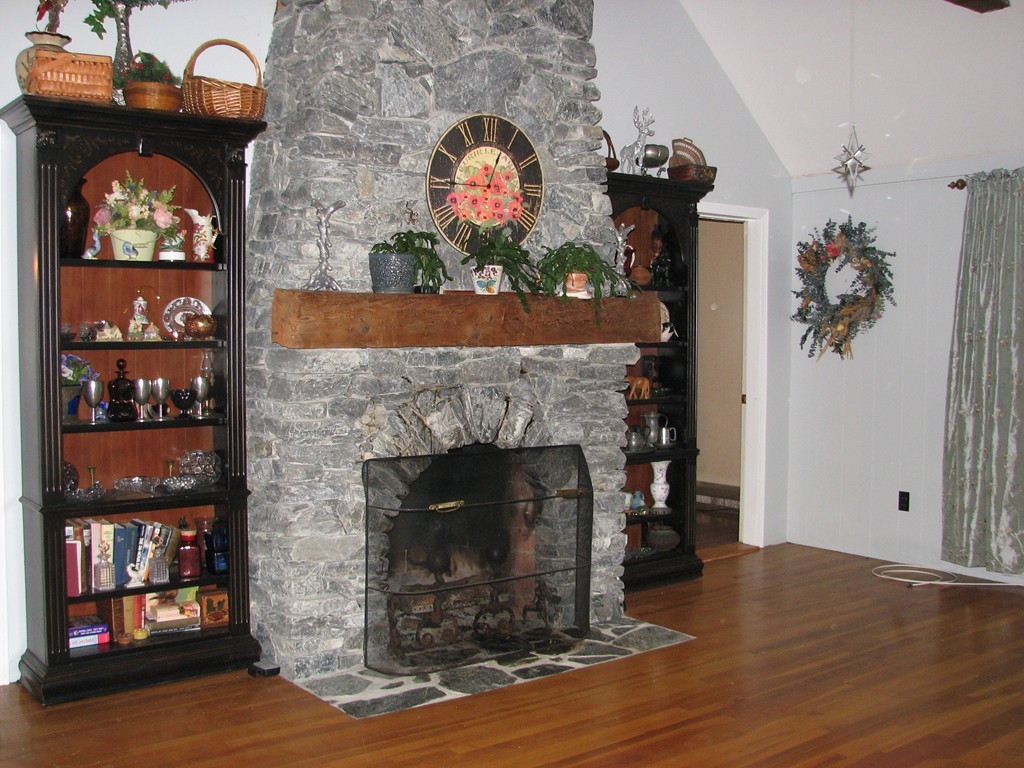 1 Lake Road Ashburnham, MA 01430 - Photo 5 of 14 a living room with a fireplace and a wooden floor