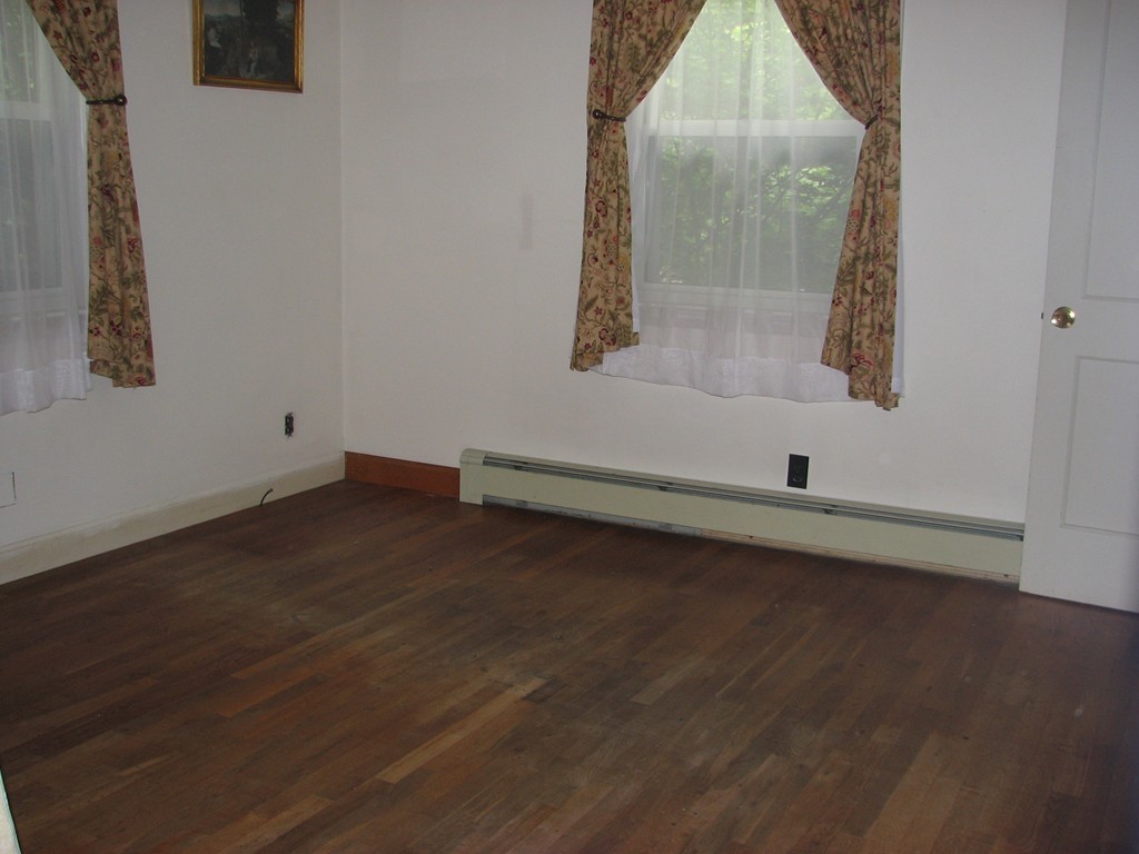 1 Lake Road Ashburnham, MA 01430 - Photo 7 of 14 an empty room with wooden floor and mirror
