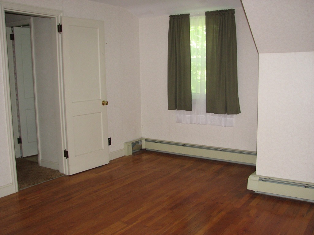 1 Lake Road Ashburnham, MA 01430 - Photo 10 of 14 a view of an empty room with wooden floor and a window