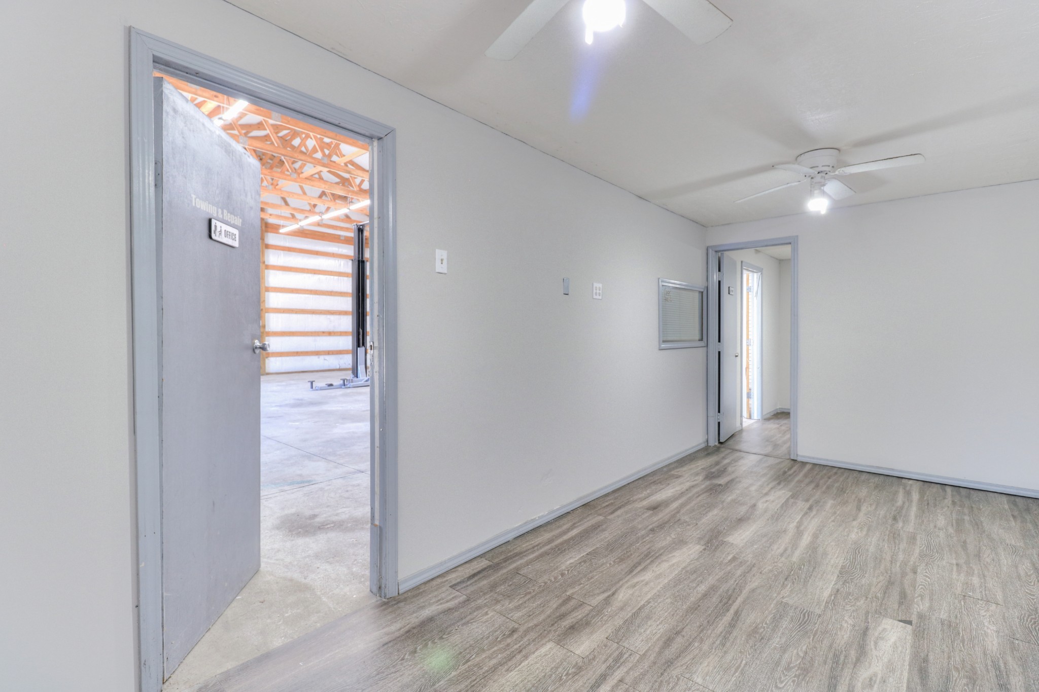 4437 Hickerson Road Manchester, TN 37355 - Photo 13 of 27 an empty room with wooden floor and windows