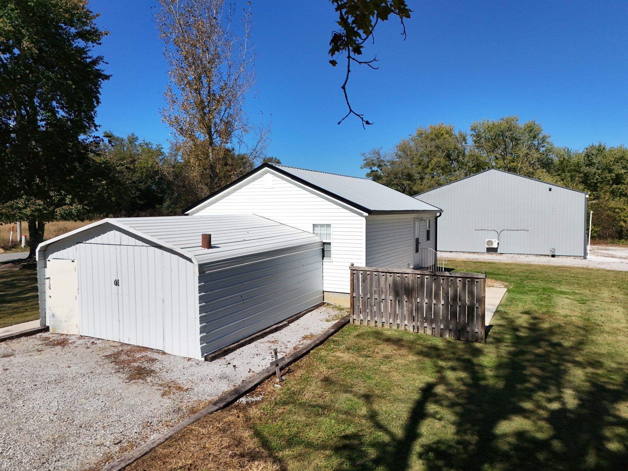 4437 Hickerson Road Manchester, TN 37355 - Photo 22 of 27 a view of a white house with a yard and a fountain