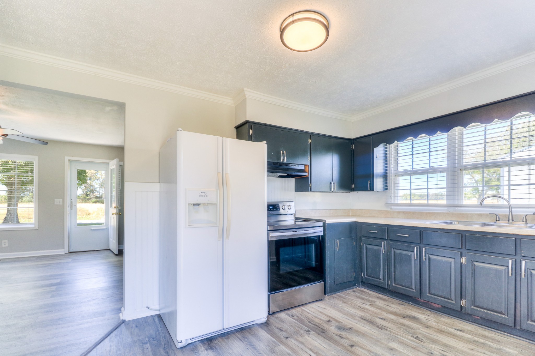 4437 Hickerson Road Manchester, TN 37355 - Photo 3 of 27 a kitchen with stainless steel appliances granite countertop a refrigerator a sink dishwasher a stove and white countertops with wooden floor
