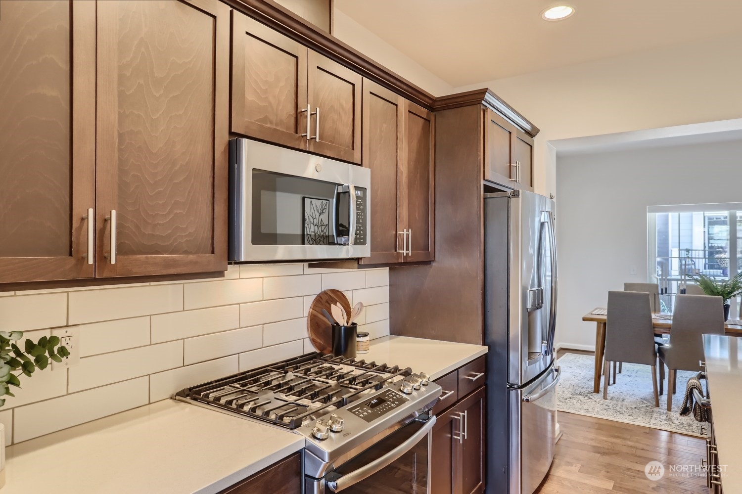 3270 Southwest Graham Street, Unit 502 Seattle, WA 98126 - Photo 11 of 32 a kitchen with stainless steel appliances granite countertop a stove a sink and a refrigerator