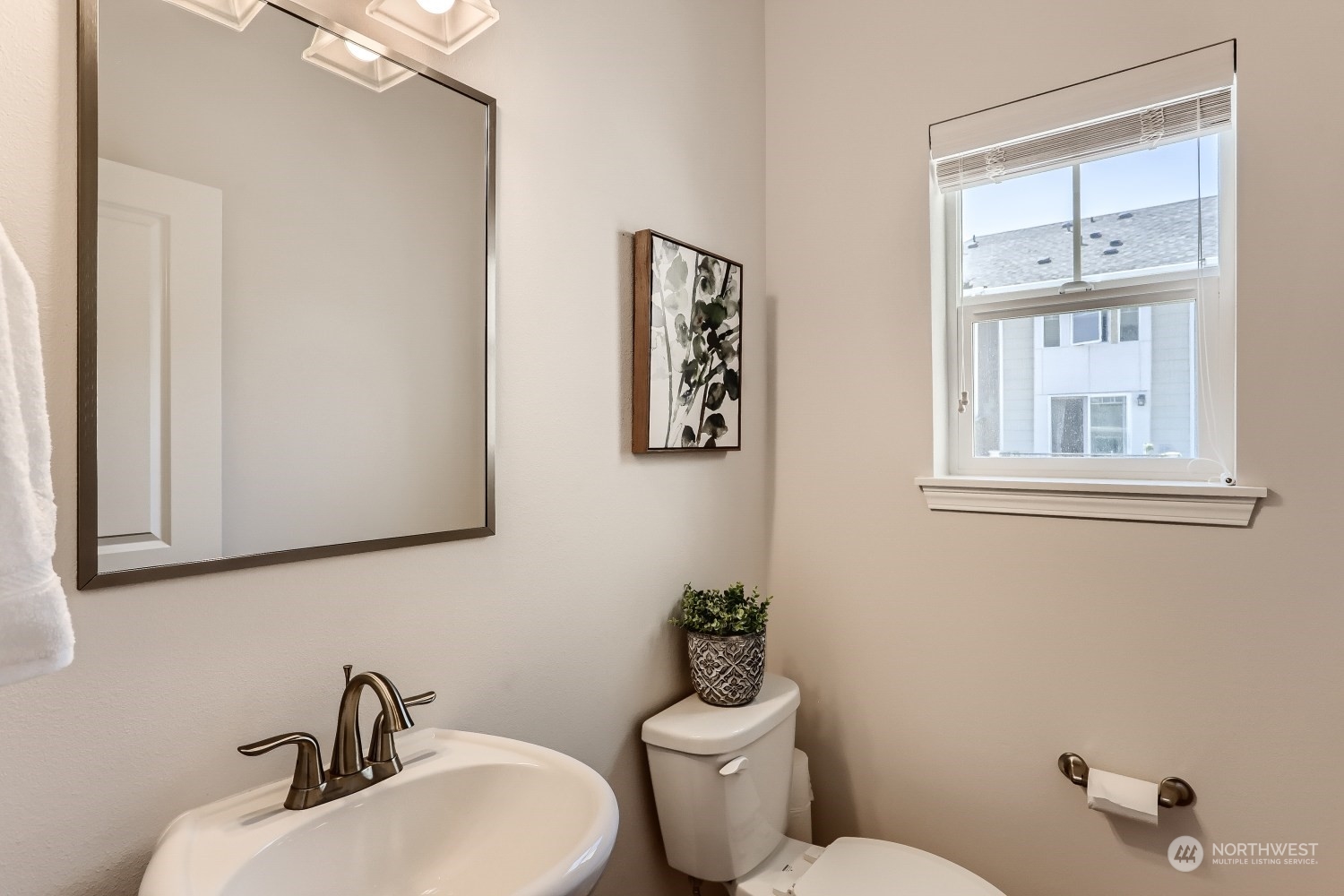 3270 Southwest Graham Street, Unit 502 Seattle, WA 98126 - Photo 17 of 32 a bathroom with a toilet a sink and mirror