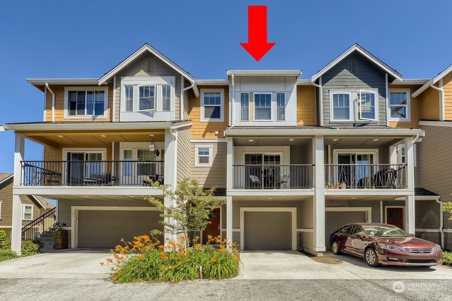 3270 Southwest Graham Street, Unit 502 Seattle, WA 98126 - Photo 2 of 32 a front view of a house with a yard and garage