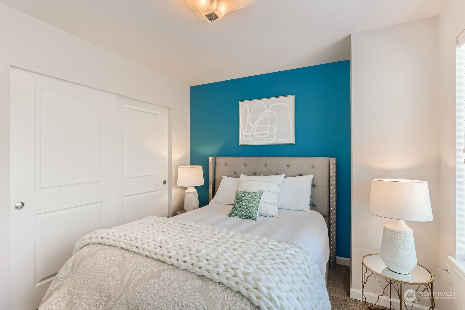 3270 Southwest Graham Street, Unit 502 Seattle, WA 98126 - Photo 22 of 32 a bedroom with a bed and a lamp on the dresser