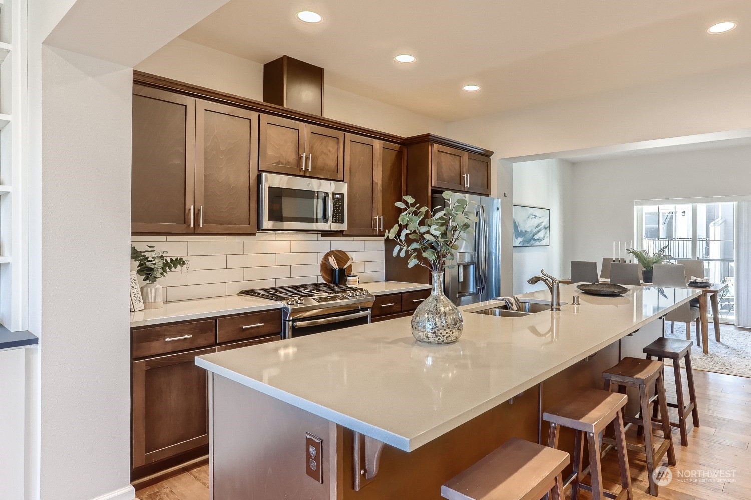 3270 Southwest Graham Street, Unit 502 Seattle, WA 98126 - Photo 5 of 32 a kitchen with kitchen island a sink stove and microwave