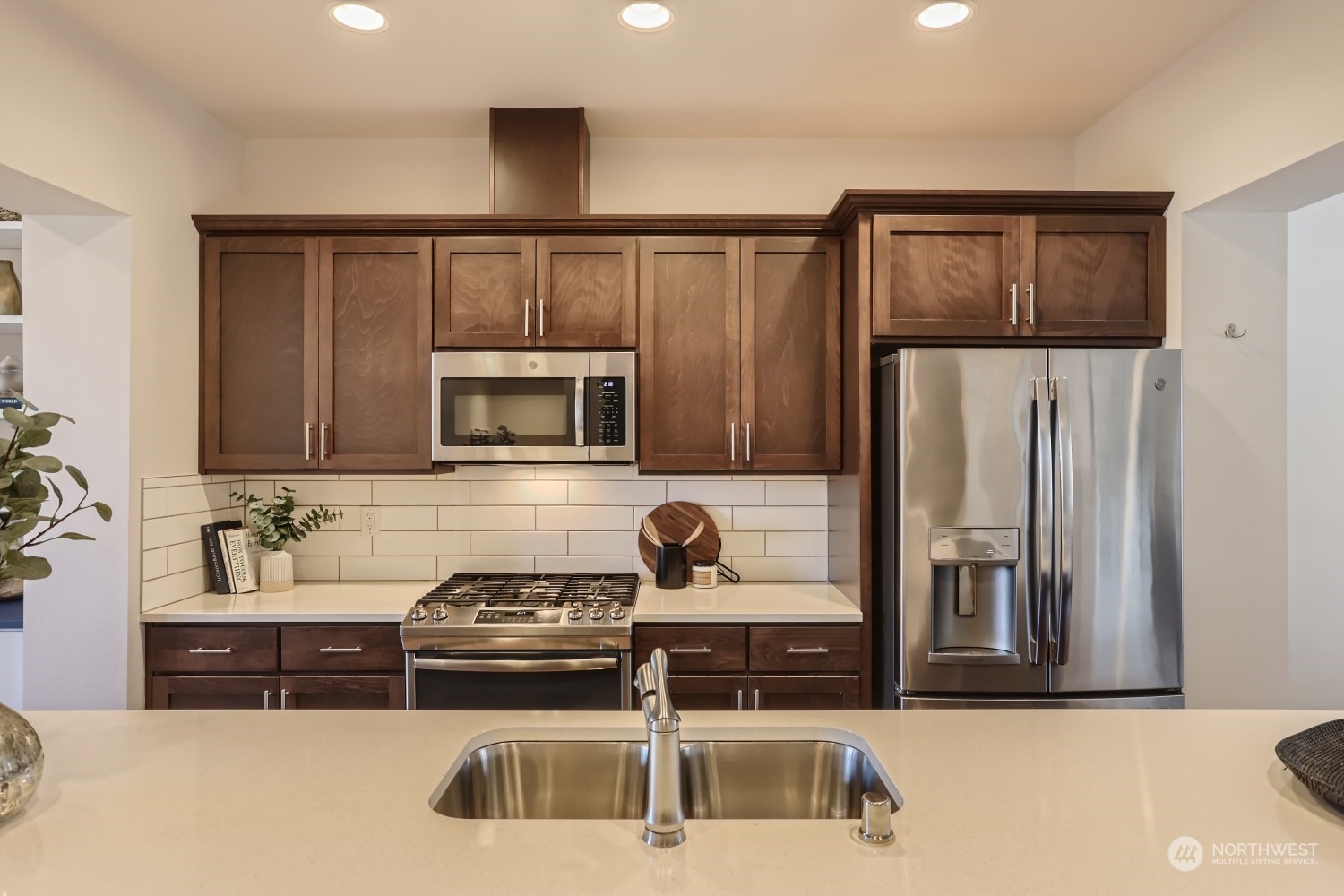 3270 Southwest Graham Street, Unit 502 Seattle, WA 98126 - Photo 6 of 32 a kitchen with stainless steel appliances a refrigerator sink and microwave
