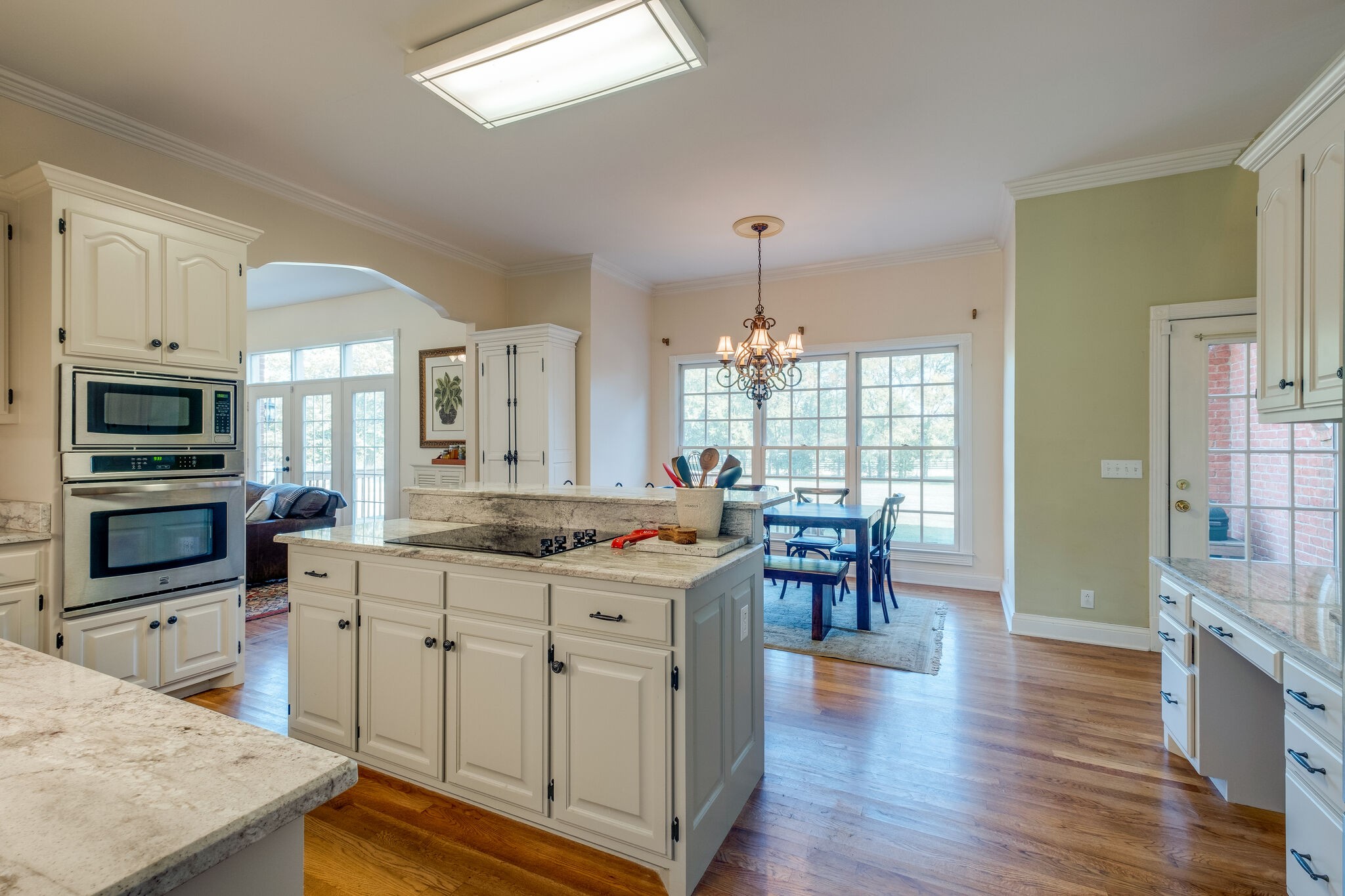 6232 Arno Road Franklin, TN 37064 - Photo 8 of 50 a kitchen with stainless steel appliances granite countertop a stove and a wooden floors