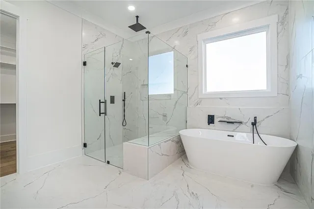 a bathroom with a bathtub and a shower