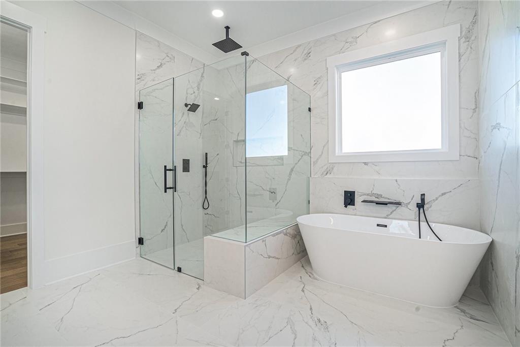 5745 Union Church Road Braselton, GA 30517 - Photo 11 of 16 a bathroom with a bathtub and a shower