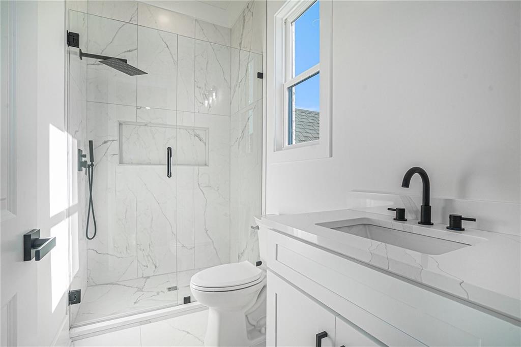 5745 Union Church Road Braselton, GA 30517 - Photo 15 of 16 a bathroom with a sink a toilet and shower
