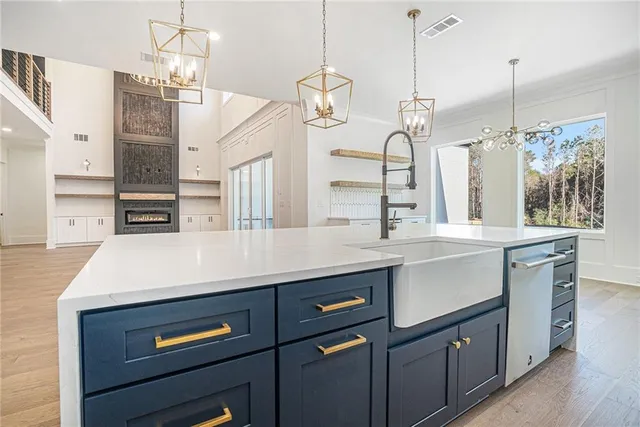 a kitchen with a sink a counter space cabinets and appliances