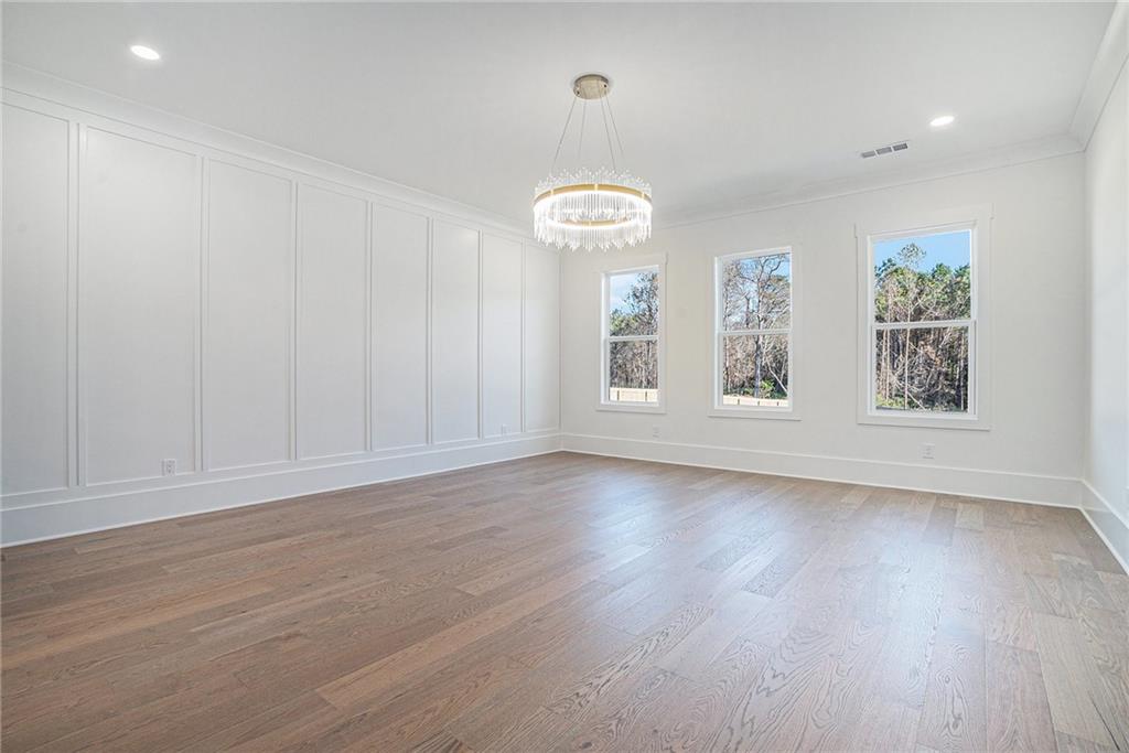 5745 Union Church Road Braselton, GA 30517 - Photo 9 of 16 an empty room with wooden floor and windows