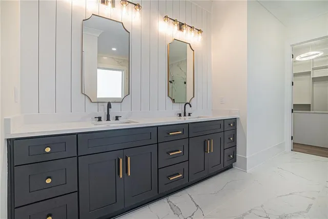 a bathroom with a double vanity sink and a mirror