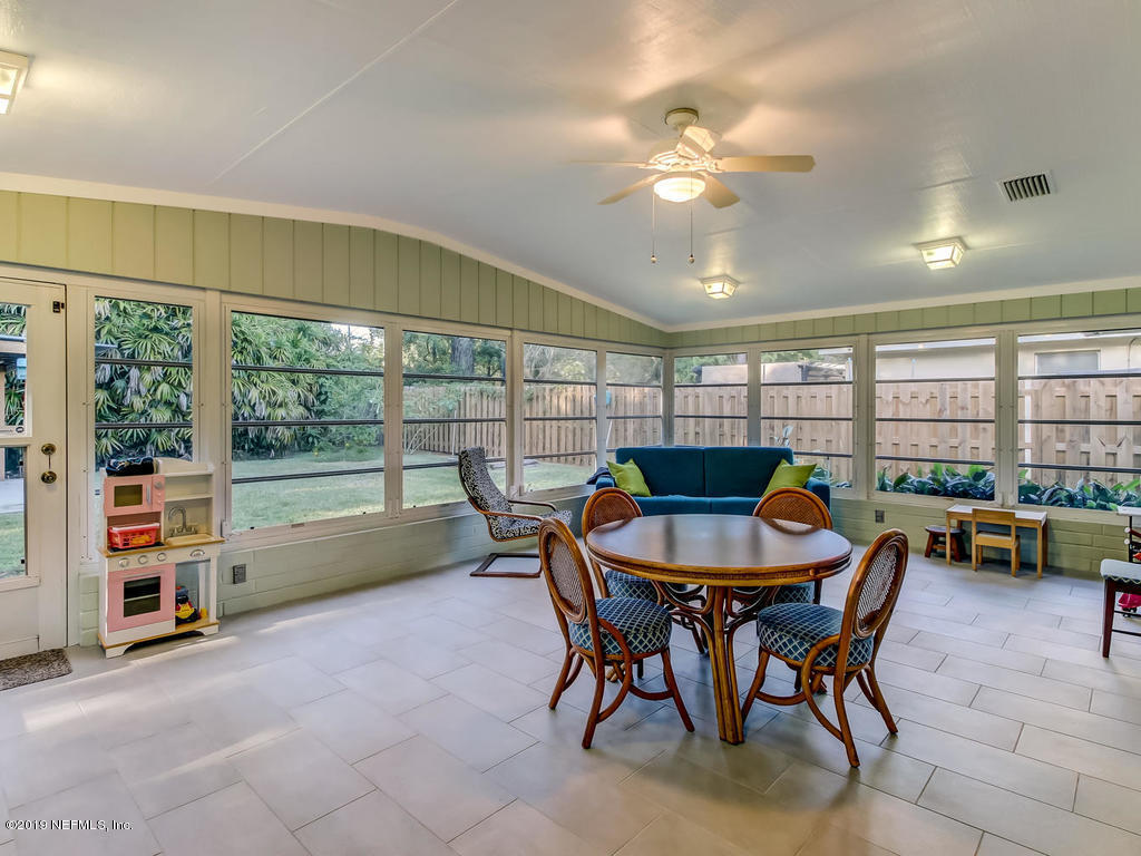 4629 Homestead Road Jacksonville, FL 32210 - Photo 14 of 27 a dining room with furniture and a floor to ceiling window