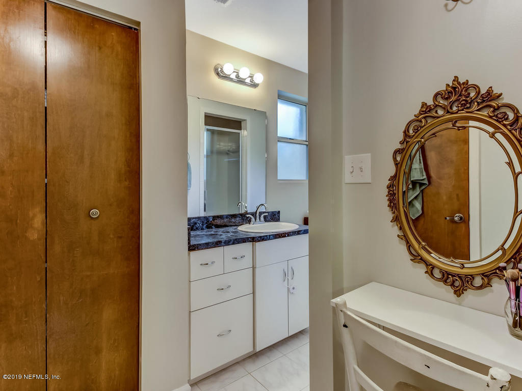 4629 Homestead Road Jacksonville, FL 32210 - Photo 17 of 27 a bathroom with a sink a toilet and a mirror