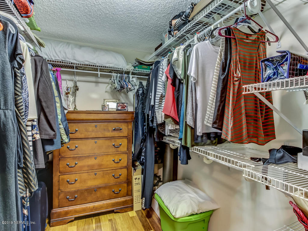 4629 Homestead Road Jacksonville, FL 32210 - Photo 18 of 27 a view of walk in closet with clothes and shoes
