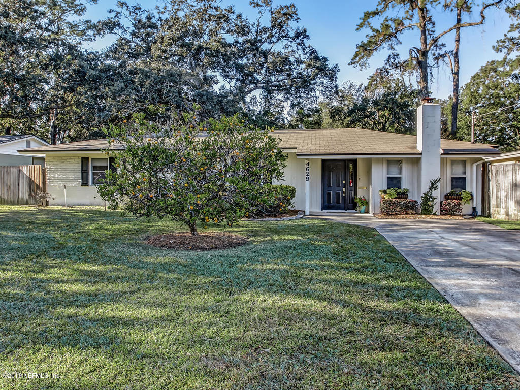 4629 Homestead Road Jacksonville, FL 32210 - Photo 2 of 27 a front view of a house with garden and trees