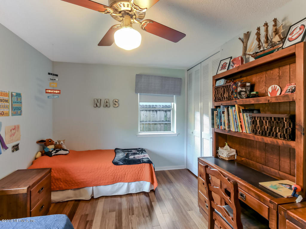 4629 Homestead Road Jacksonville, FL 32210 - Photo 22 of 27 a bedroom with furniture and a window