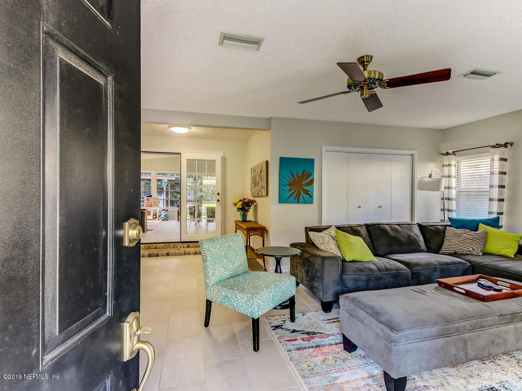4629 Homestead Road Jacksonville, FL 32210 - Photo 3 of 27 a living room with furniture and a wooden floor