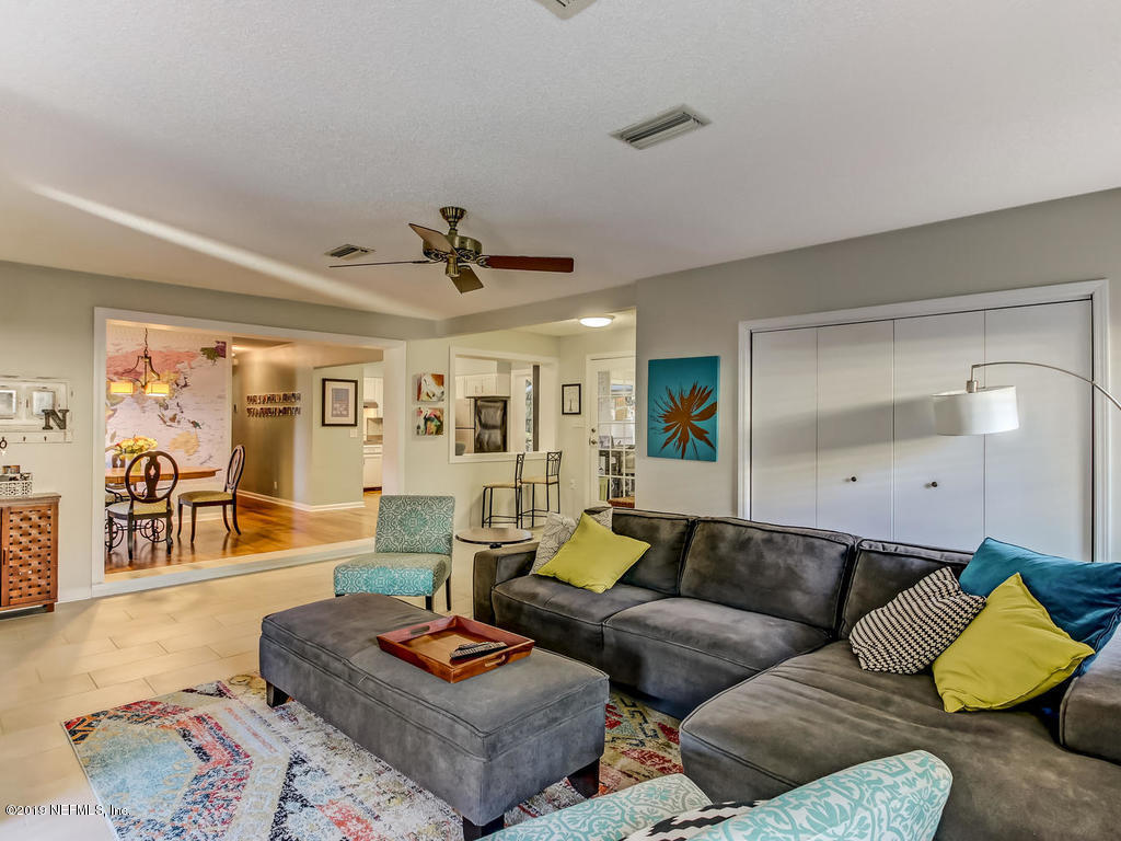 4629 Homestead Road Jacksonville, FL 32210 - Photo 5 of 27 a living room with furniture and a wooden floor