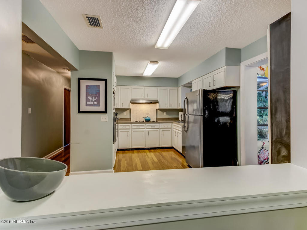 4629 Homestead Road Jacksonville, FL 32210 - Photo 10 of 27 a kitchen with a refrigerator and a sink
