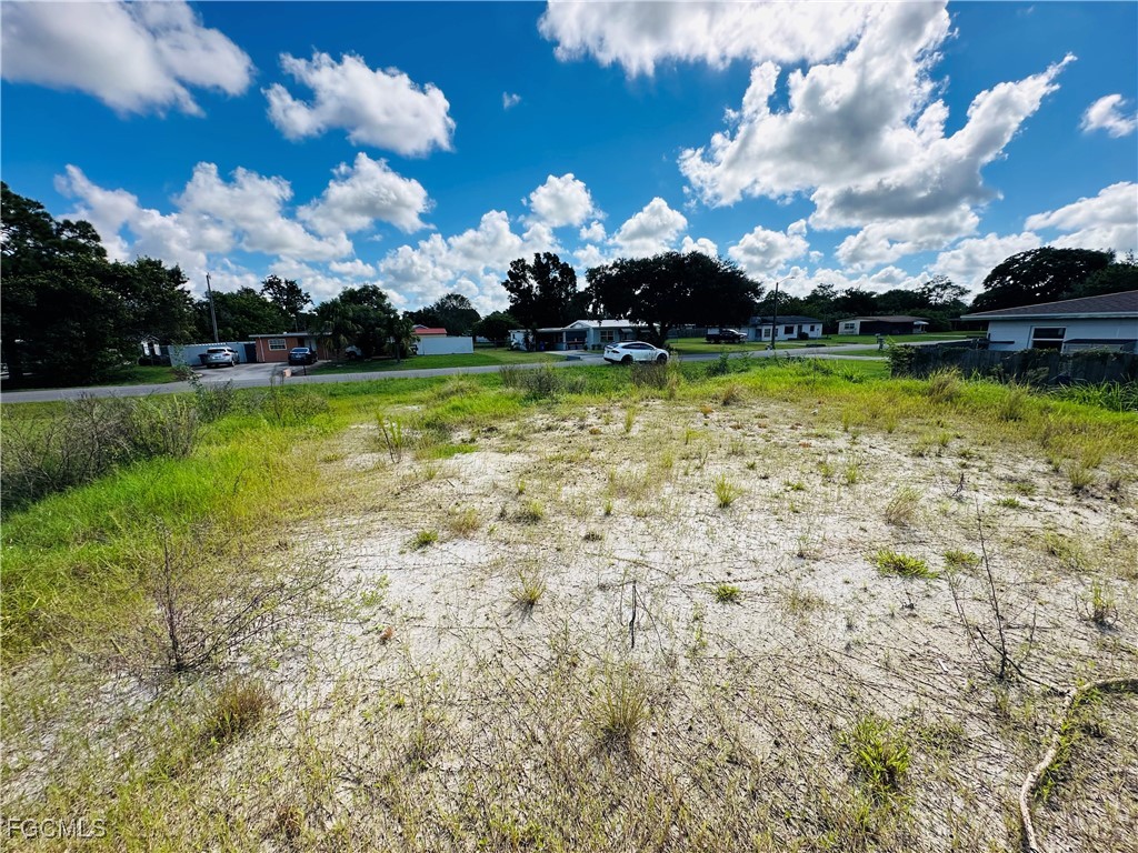 111 Connecticut Road Lehigh Acres, FL 33936 - Photo 5 of 8 a view of a lake with houses in back