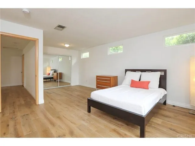 a bedroom with a bed and a table