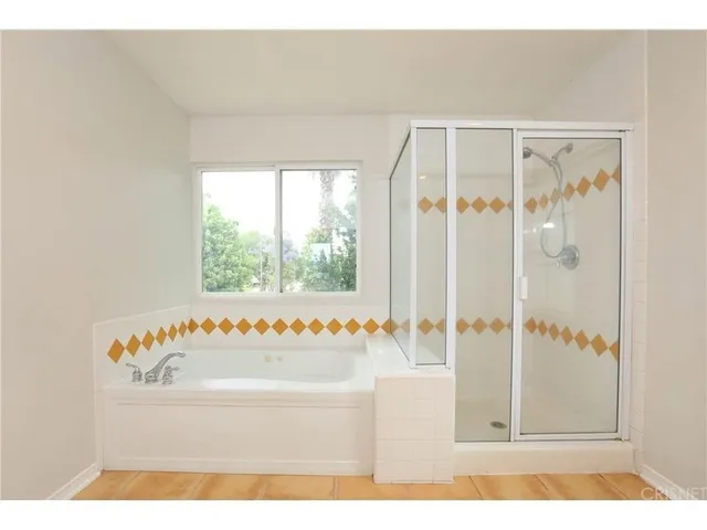 a bathroom with a tub and a shower