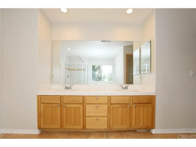 a bathroom with a sink a mirror and a vanity