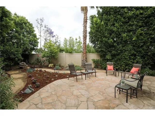 a view of a backyard with sitting area