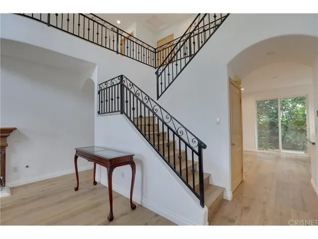 a view of entryway and hall with wooden floor