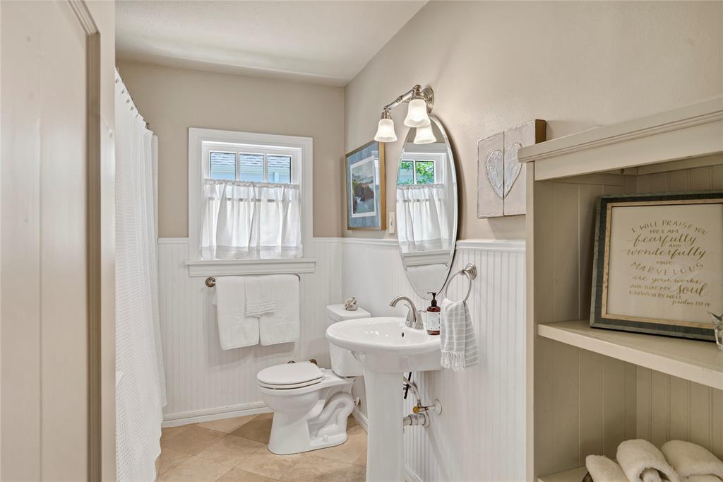 3170 Westcliff Road West Fort Worth, TX 76109 - Photo 21 of 39 a bathroom with a toilet sink and mirror