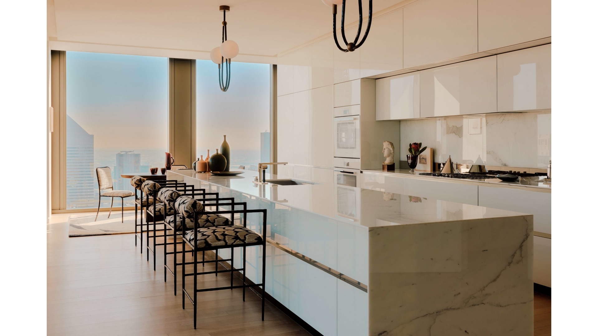 53 West 53rd Street, Unit 66 Manhattan, NY 10019 - Photo 5 of 15 a kitchen with table chairs and a dining table