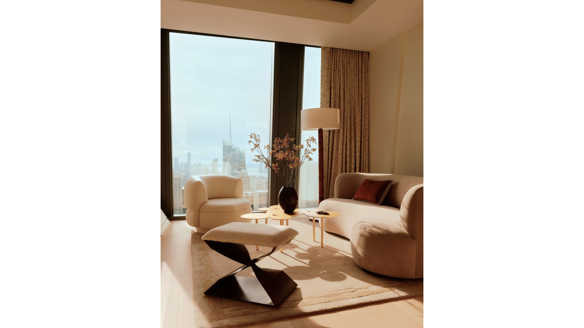 53 West 53rd Street, Unit 66 Manhattan, NY 10019 - Photo 7 of 15 a living room with furniture and a table