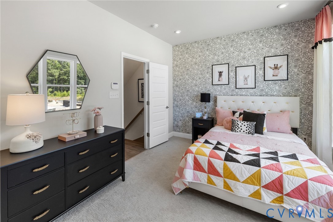 16112 Esteem Way Midlothian, VA 23113 - Photo 21 of 42 a bedroom with a bed and a dresser in it