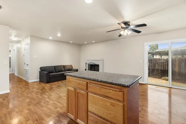 a kitchen with stainless steel appliances granite countertop a sink and a refrigerator