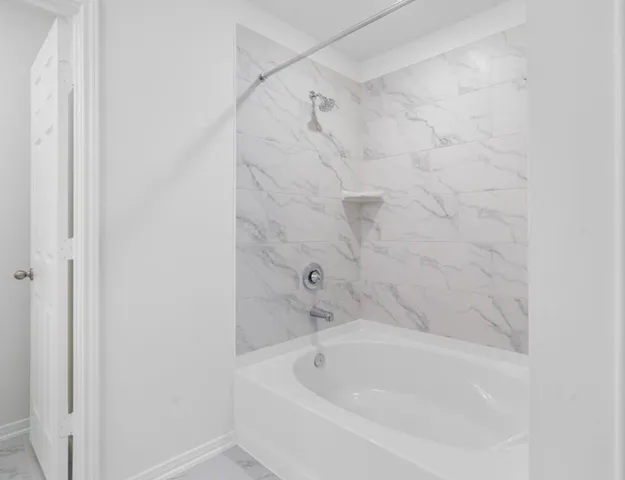 a bathroom with a tub and shower