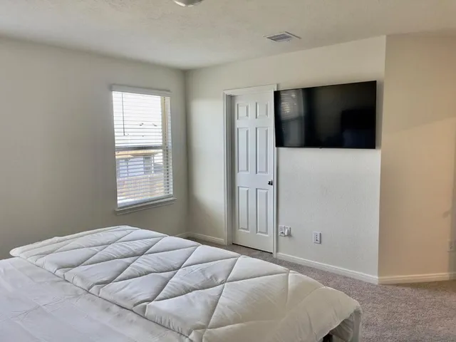 a bedroom with a bed and a window