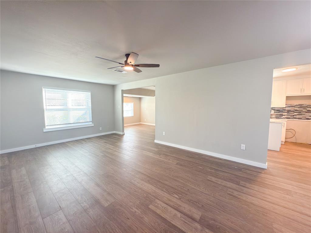2431 Marfa Avenue Dallas, TX 75216 - Photo 12 of 39 wooden floor in an empty room with a window