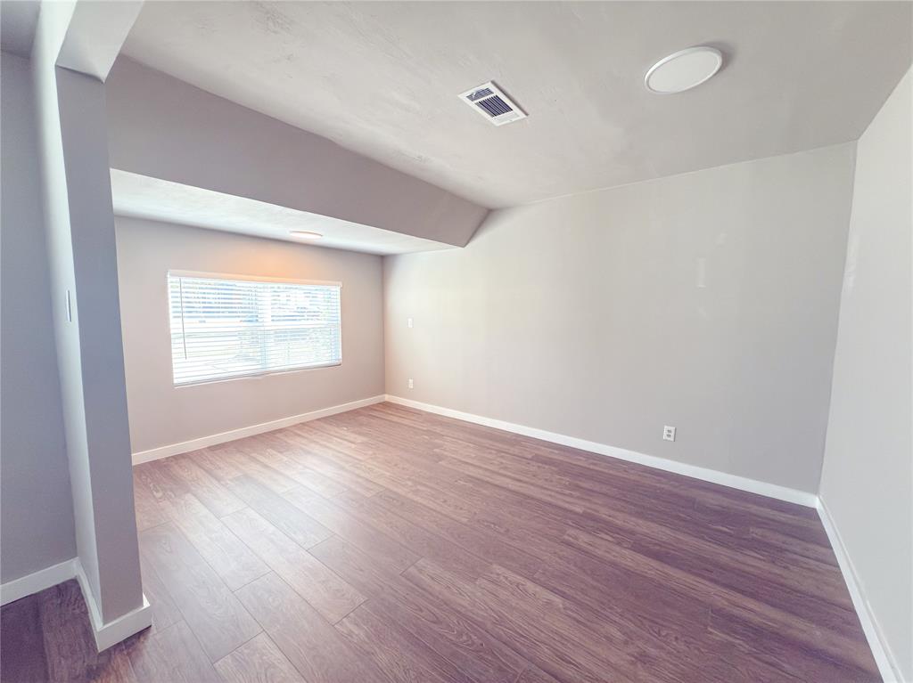 2431 Marfa Avenue Dallas, TX 75216 - Photo 15 of 39 an empty room with wooden floor and windows