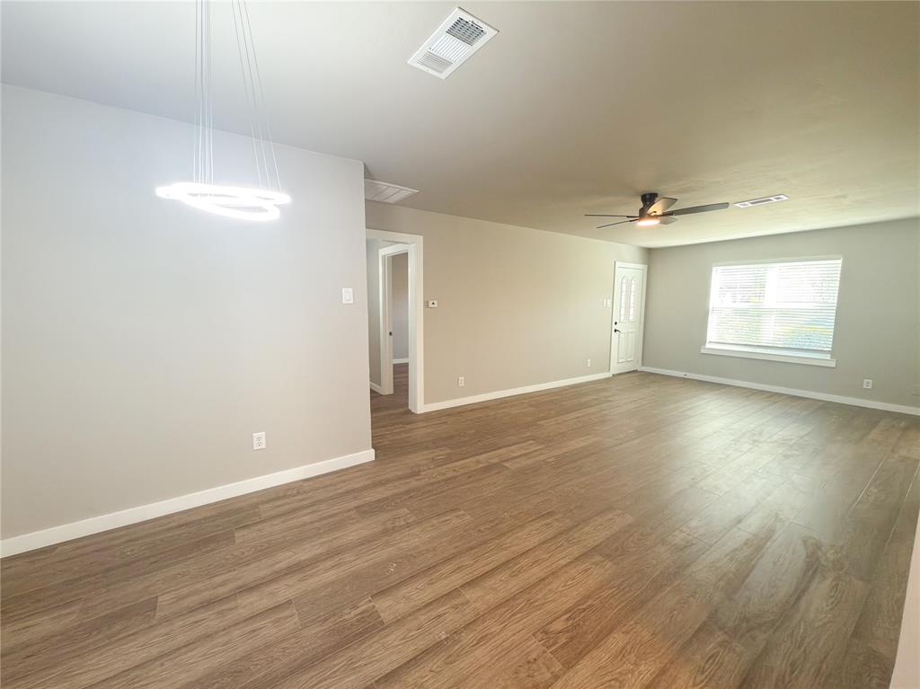 2431 Marfa Avenue Dallas, TX 75216 - Photo 22 of 39 an empty room with wooden floor and windows