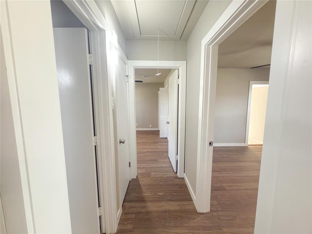 2431 Marfa Avenue Dallas, TX 75216 - Photo 23 of 39 a view of a hallway with wooden floor