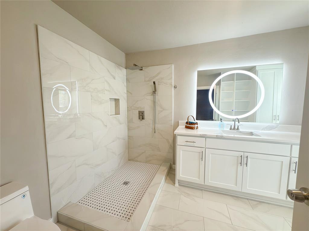 2431 Marfa Avenue Dallas, TX 75216 - Photo 25 of 39 a bathroom with a sink a toilet and shower